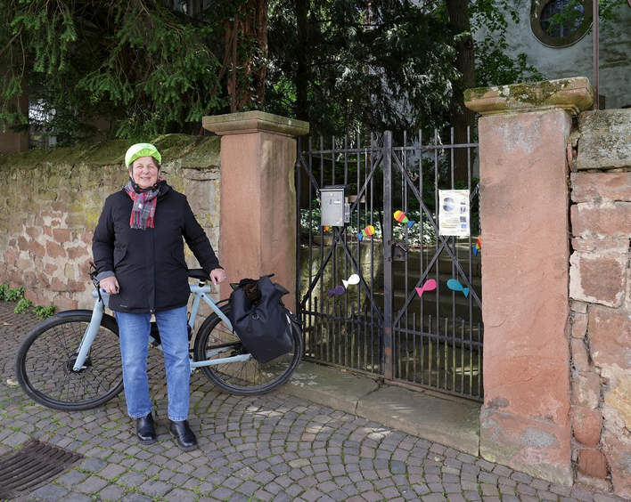 Lädt zum ­Mitradeln ein: Pfarrerin Elke Wedler-Krüger vor der Kirche Kleinfisch­lingen. Foto: Norman Krauß