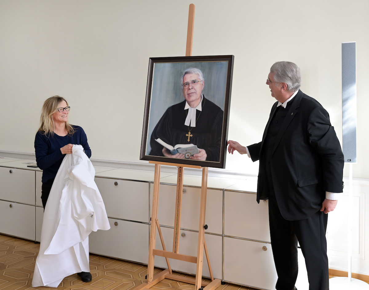 Die Künstlerin Susanna Storch und Kirchenpräsident Christian Schad enthüllen das Portrait. Foto: lk/Landry.